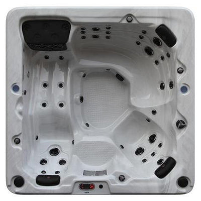 Toronto UV 6-person hot tub with lounger seat and 44 jets, installed in a UK garden — Canadian Spa Company UK