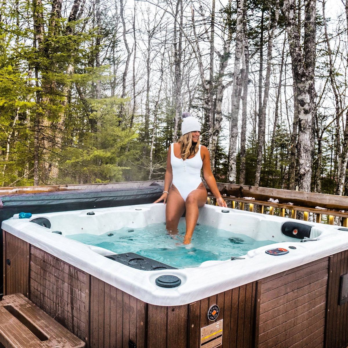 A Canadian Spa Company hot tub running in a Manitoba birch forest in winter