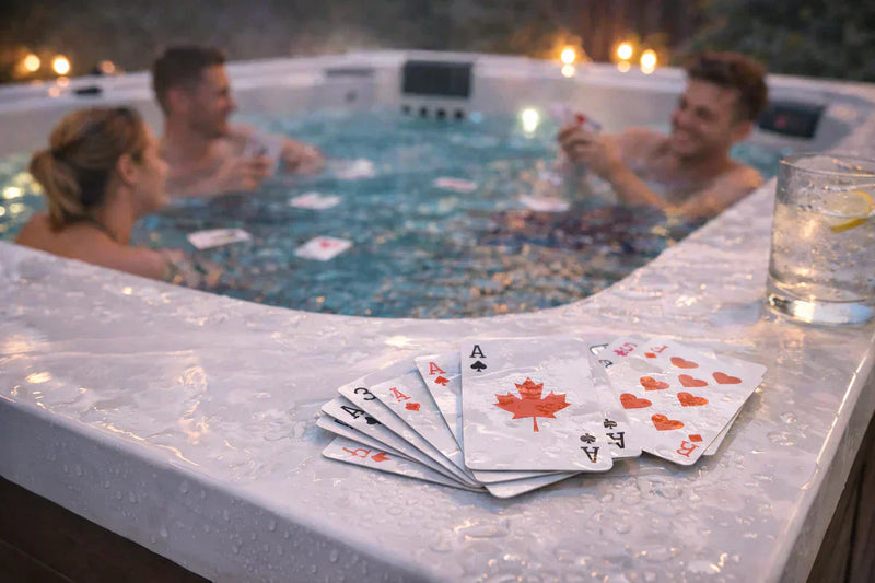 Waterproof playing cards on the edge of a hot tub during an evening soak, showing people enjoying a relaxed hot tub game night with bubbles and ambient lighting.