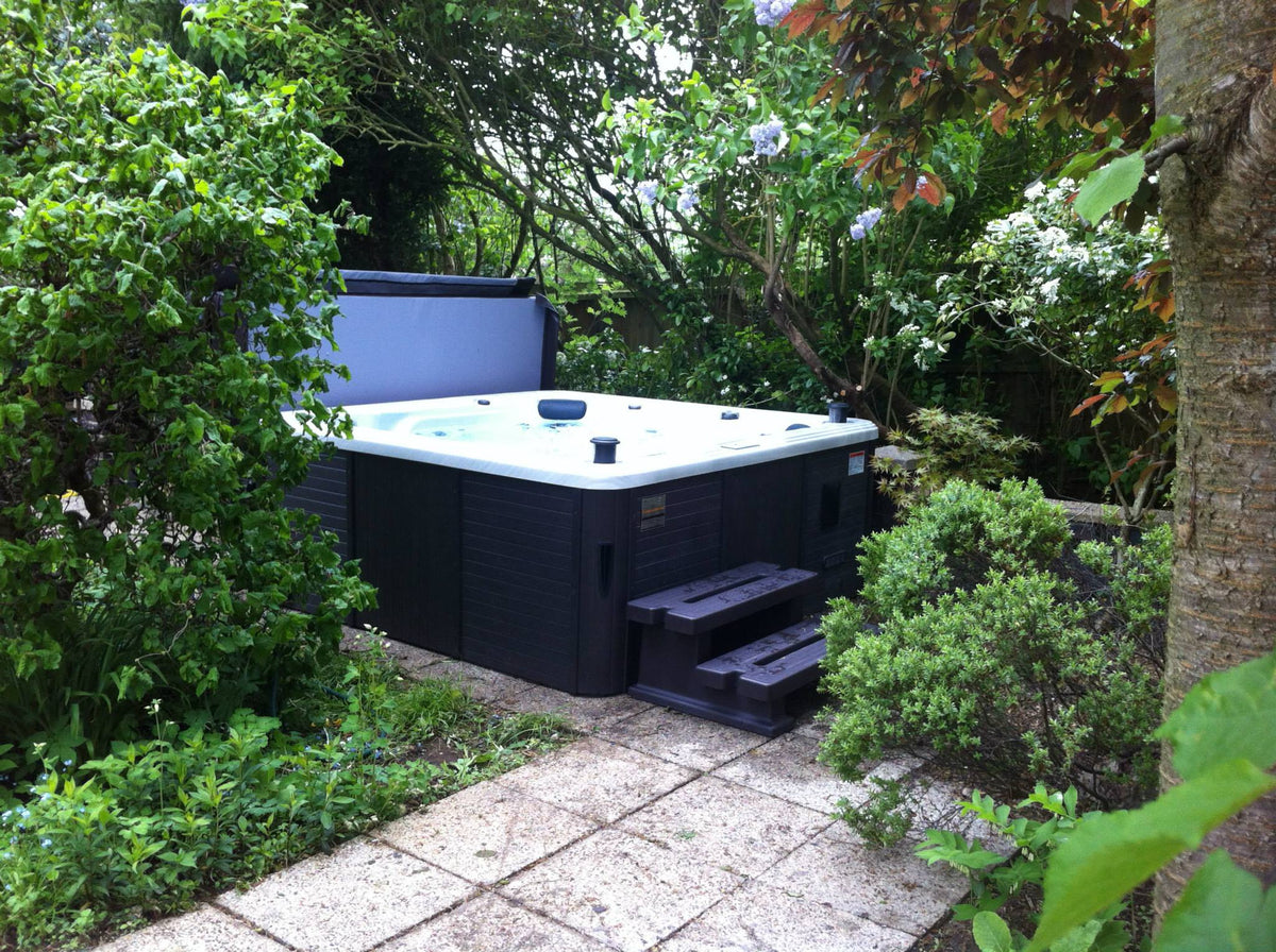
Hardwired 6-person acrylic hot tub installed in a UK garden — 32A models from Canadian Spa Company